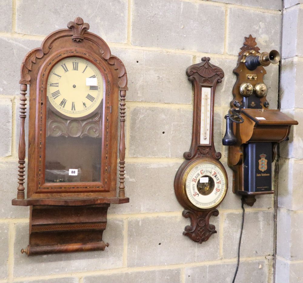 An American walnut wall clock, a late Victorian aneroid wheel barometer and a vintage style telephone
